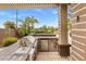 Outdoor kitchen with built-in grill, refrigerator, and bar seating on covered patio at 654 E County Down Dr, Chandler, AZ 85249