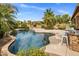 Lush backyard featuring a sparkling pool, mature landscaping, and fireplace at 654 E County Down Dr, Chandler, AZ 85249