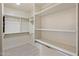 Organized walk-in closet offering ample storage space with shelving and rods for clothing and accessories at 654 E County Down Dr, Chandler, AZ 85249
