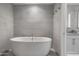 Elegant bathroom featuring a soaking tub with stylish fixtures and neutral tile at 7180 E Kierland Blvd # 814, Scottsdale, AZ 85254