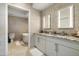 Modern bathroom featuring double sinks, granite countertops, and a soaking tub at 7180 E Kierland Blvd # 814, Scottsdale, AZ 85254