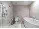 Modern bathroom featuring a glass-enclosed shower, soaking tub, and neutral tile at 7180 E Kierland Blvd # 814, Scottsdale, AZ 85254