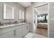 Elegant bathroom with double sinks, granite countertops, and an open view to the bedroom at 7180 E Kierland Blvd # 814, Scottsdale, AZ 85254