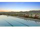 Beautiful infinity pool overlooking the city skyline with mountains in the background at sunset at 7180 E Kierland Blvd # 814, Scottsdale, AZ 85254