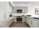 Well-lit kitchen with modern appliances, gray cabinetry, and granite countertops at 7180 E Kierland Blvd # 814, Scottsdale, AZ 85254