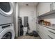A well-organized laundry room with stacked washer/dryer and ample storage at 7180 E Kierland Blvd # 814, Scottsdale, AZ 85254