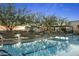 Relaxing pool deck features comfortable lounge chairs and lush trees with views of the city at 7180 E Kierland Blvd # 814, Scottsdale, AZ 85254