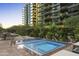 Outdoor pool and spa area with landscaped grounds and high rise building in the background at 7180 E Kierland Blvd # 814, Scottsdale, AZ 85254
