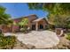 Spacious backyard features stone patio, mature trees, and a built-in outdoor grill at 7456 W Irma Ln, Glendale, AZ 85308