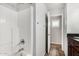 Bright bathroom features a shower over tub, wood vanity with granite counters, and tile floors at 7456 W Irma Ln, Glendale, AZ 85308