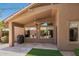 Covered patio featuring tile flooring, a built-in ceiling fan, and exterior views at 7456 W Irma Ln, Glendale, AZ 85308