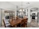 Bright dining area features a modern chandelier and sliding door access to the patio at 7456 W Irma Ln, Glendale, AZ 85308