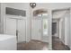 Bright foyer featuring tiled flooring, white doors, and transom window at 7456 W Irma Ln, Glendale, AZ 85308