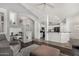 Open-concept living space with dark floors, stylish decor, and ample natural light at 7456 W Irma Ln, Glendale, AZ 85308