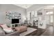 Spacious living room featuring modern furnishings, vaulted ceilings, and neutral tones at 7456 W Irma Ln, Glendale, AZ 85308