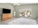 This main bedroom features neutral colors and a large dresser and mirror at 7456 W Irma Ln, Glendale, AZ 85308
