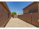 Narrow side yard with gravel cover and block wall at 7456 W Irma Ln, Glendale, AZ 85308