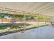 Large, grassy backyard with mature trees, a trampoline, and outdoor seating area at 7607 N 17Th Ave, Phoenix, AZ 85021