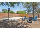 Backyard featuring a basketball hoop and outdoor seating with mature shade trees at 7607 N 17Th Ave, Phoenix, AZ 85021