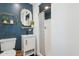 Chic bathroom features a navy accent wall and geometric tile floors with a walk-in shower at 7607 N 17Th Ave, Phoenix, AZ 85021