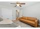 Cozy bedroom featuring a leather sofa, hardwood floors, and a patterned rug at 7607 N 17Th Ave, Phoenix, AZ 85021