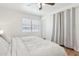 Bright bedroom features wood floors, a ceiling fan, and a large window with horizontal blinds at 7607 N 17Th Ave, Phoenix, AZ 85021