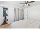 Bright bedroom features wood floors and a ceiling fan near an ensuite bathroom at 7607 N 17Th Ave, Phoenix, AZ 85021