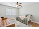 Bright bedroom with daybed, leather sofa, hardwood floors, and a patterned rug at 7607 N 17Th Ave, Phoenix, AZ 85021