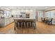 Bright kitchen with white cabinetry, stainless steel appliances, large island with seating, and stylish tile backsplash at 7607 N 17Th Ave, Phoenix, AZ 85021