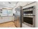 Bright kitchen featuring stainless steel appliances, white cabinets, subway tile backsplash, and wood floors at 7607 N 17Th Ave, Phoenix, AZ 85021