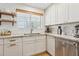 This updated kitchen is equipped with white cabinets, modern countertops, and stainless steel appliances at 7607 N 17Th Ave, Phoenix, AZ 85021