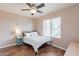 Bedroom showcasing wood floors, a ceiling fan, and a large window at 822 E Ross Ave, Phoenix, AZ 85024