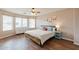 Cozy bedroom featuring a large window, wood floors, and natural light at 822 E Ross Ave, Phoenix, AZ 85024