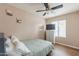 Cozy bedroom features modern ceiling fan, dresser, and neutral wall color at 822 E Ross Ave, Phoenix, AZ 85024