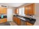 Functional kitchen area with modern appliances, wood cabinetry, and ample counter space for meal prep at 822 E Ross Ave, Phoenix, AZ 85024