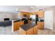 Modern kitchen featuring stainless steel appliances, wood cabinets, and an open layout to the living area at 822 E Ross Ave, Phoenix, AZ 85024