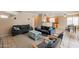 Open-concept living room with view of the kitchen, comfortable seating, and neutral wall colors at 822 E Ross Ave, Phoenix, AZ 85024