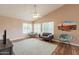 Bright living room with comfortable seating, ceiling fan, and desert wall art at 822 E Ross Ave, Phoenix, AZ 85024