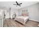 Bright bedroom with modern decor, light wood floors, and a cozy bed setting at 9034 W Eagle Talon Dr, Peoria, AZ 85383