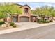 Beautiful home with a three-car garage, stone accents, and manicured front yard at 9034 W Eagle Talon Dr, Peoria, AZ 85383