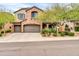 Charming two-story home with a three car garage, stone accents and low-maintenance landscaping at 9034 W Eagle Talon Dr, Peoria, AZ 85383