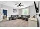 Comfortable living room featuring a large sectional sofa, neutral tones and a ceiling fan at 9034 W Eagle Talon Dr, Peoria, AZ 85383