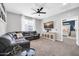Relaxing living room features a sectional sofa, ceiling fan, and mounted TV at 9034 W Eagle Talon Dr, Peoria, AZ 85383