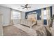 Main bedroom featuring a king bed, neutral tones, and bright natural light at 9034 W Eagle Talon Dr, Peoria, AZ 85383