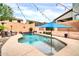 Charming pool with a tanning shelf, patio, and lush landscaping, perfect for outdoor relaxation at 9034 W Eagle Talon Dr, Peoria, AZ 85383