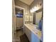 Bathroom showcasing white vanity with sink, mirror, modern lighting, and tub/shower combo at 9187 W Parkside Ln, Peoria, AZ 85383