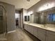 Elegant bathroom featuring dual sinks, ample counter space, and a glass-enclosed shower at 9187 W Parkside Ln, Peoria, AZ 85383