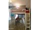 Bedroom featuring a bunk bed with ladder, desk, shelving, gray walls, and carpet flooring at 9187 W Parkside Ln, Peoria, AZ 85383
