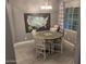 Cozy dining area with a round table, four chairs, and a decorative map at 9187 W Parkside Ln, Peoria, AZ 85383