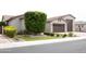 Charming home featuring manicured landscaping, an expansive driveway, and a spacious two-car garage at 9187 W Parkside Ln, Peoria, AZ 85383